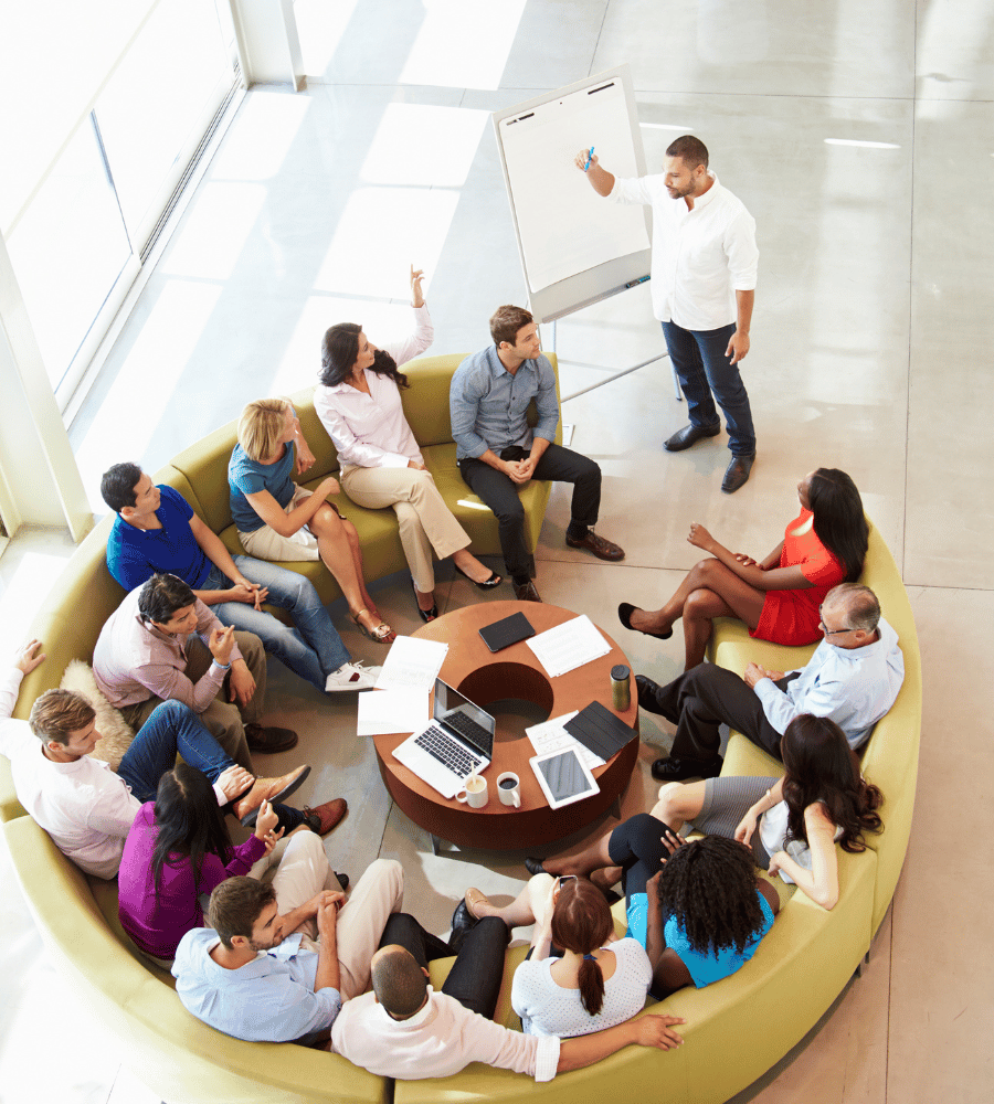 group-sitting-on-couch-listening-to-speaker