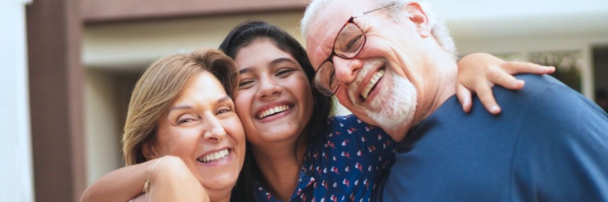 two-parents-hugging-grown-daughter